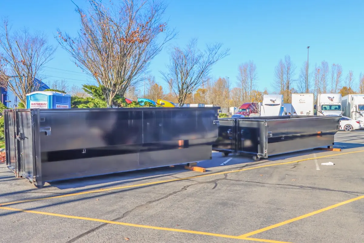 Professional dumpster rental service with roll-off container on residential driveway in Tualatin